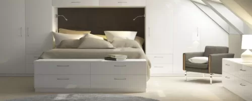 Serene white bedroom with complete fitted furniture suite