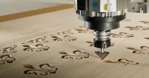 CNC machine cutting fleur-de-lis patterns in wood sheet